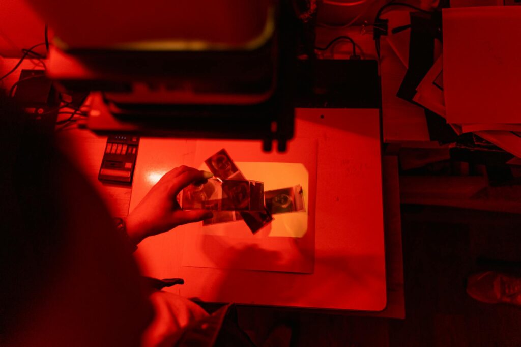 Close-up shot of a hand signing a legal document labeled 'Producer Agreement' with a pen.