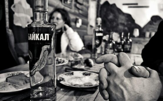 A person relaxing with their feet propped up, enjoying a healthy green smoothie.