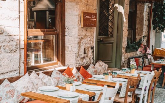 A quiet, narrow cobblestone street in an old European city, bathed in the warm, golden light of sunrise.