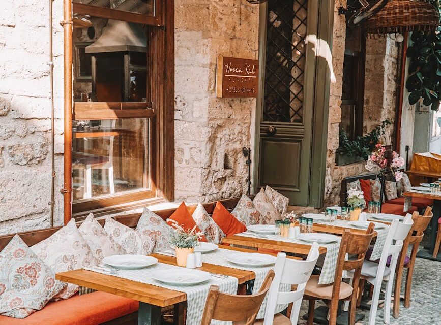 A quiet, narrow cobblestone street in an old European city, bathed in the warm, golden light of sunrise.