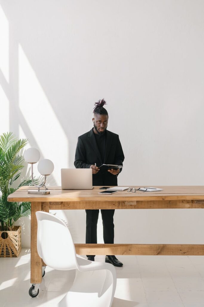 A detailed financial close process checklist lying on a desk next to an open laptop.