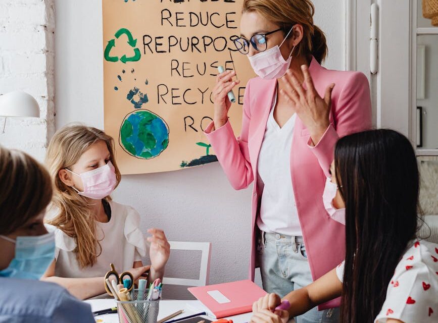 A diverse group of students working together on a project in a bright, modern classroom.