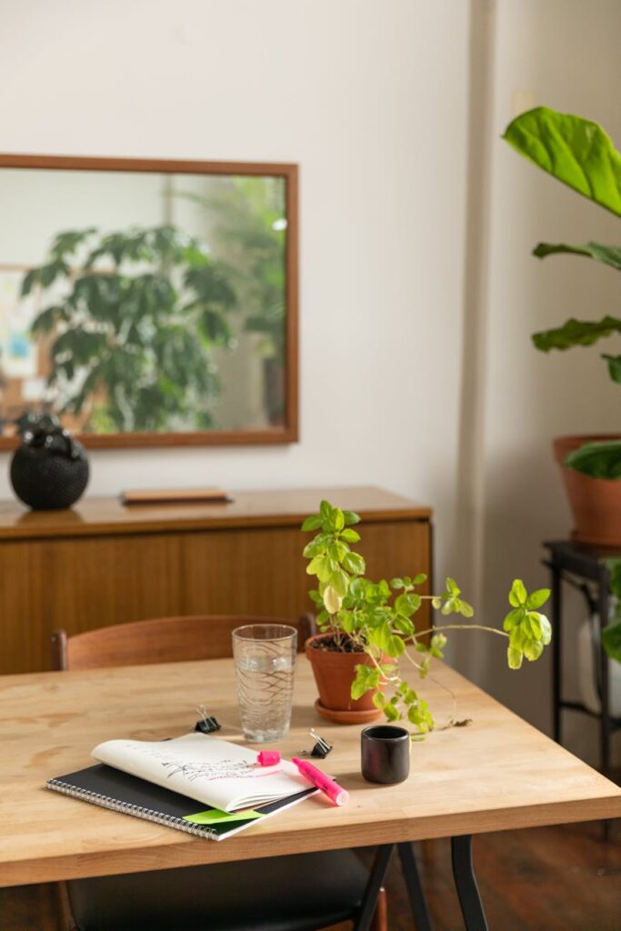 A clean and organized desk setup with a laptop, notebooks, and a lamp, ready for a proctored exam.