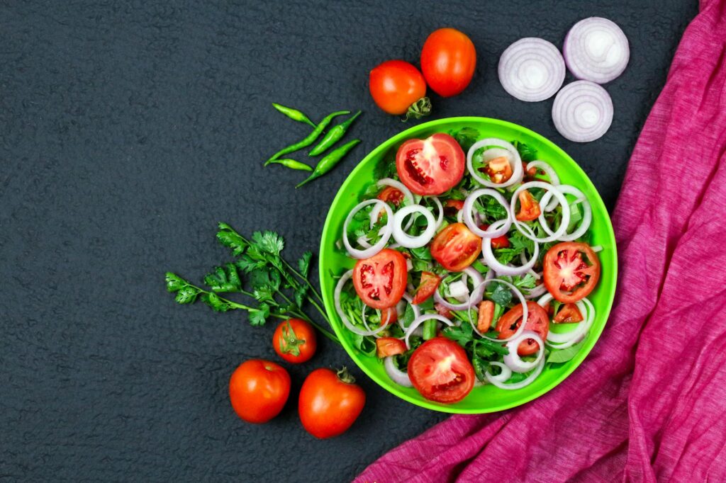 A fresh and crisp salad in a white bowl, with vibrant kale, cherry tomatoes, and sliced almonds, highlighting a healthy meal.