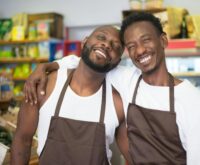 A supermarket aisle filled with brightly colored packages of processed snack foods and cereals.