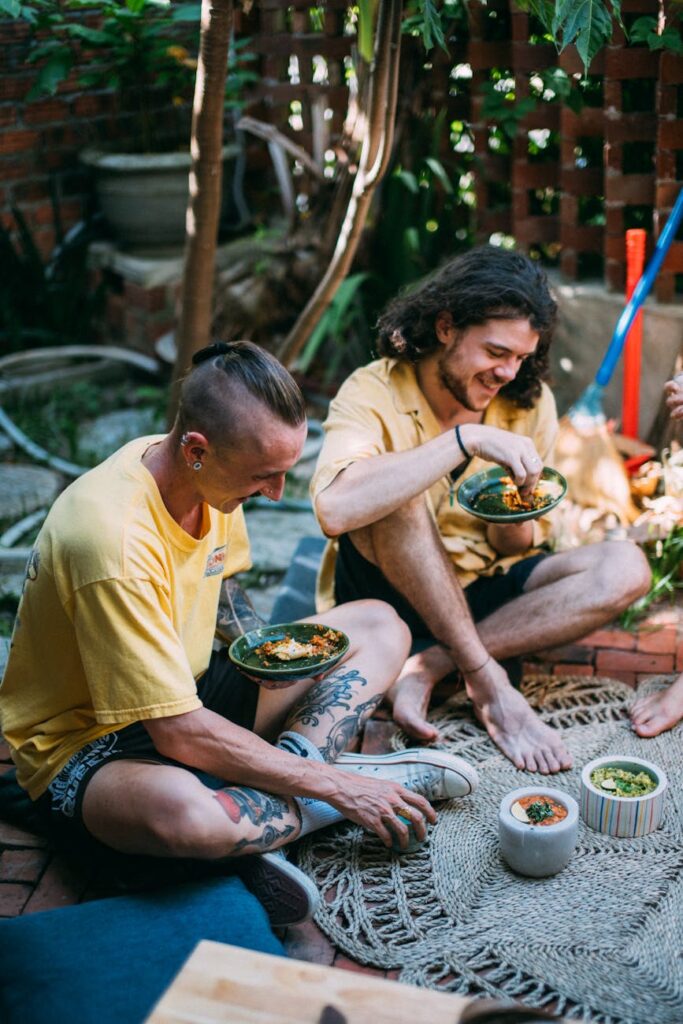 Happy students wearing gloves plant seedlings together during a community service event, showing teamwork and purpose.