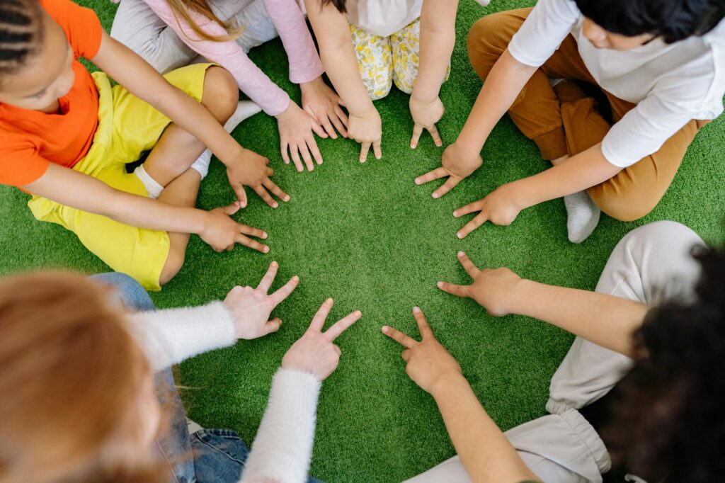 A diverse group of stundets gathered around a table, brainstorming and collaborating on a creative assignment.