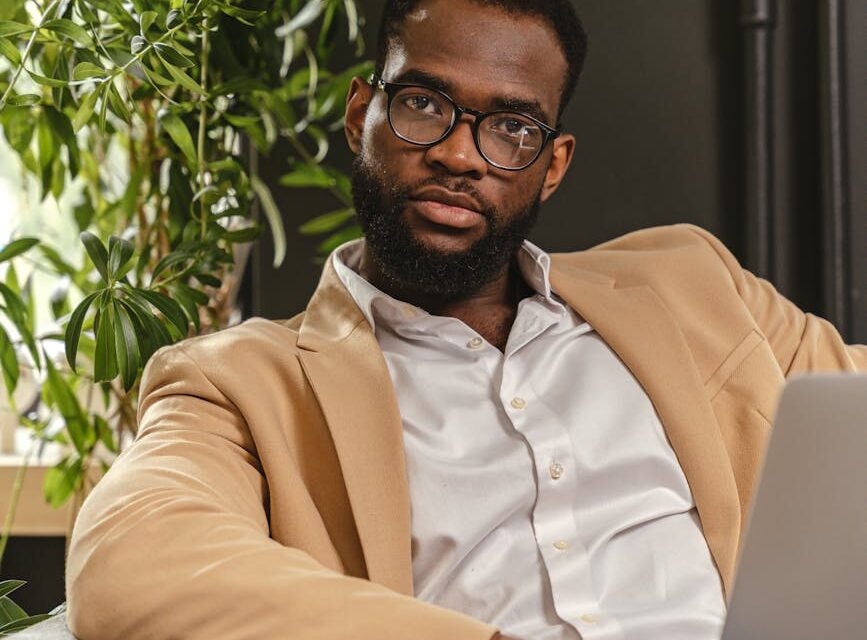 A focused entrepreneur meticulously planning their business launch on a laptop.